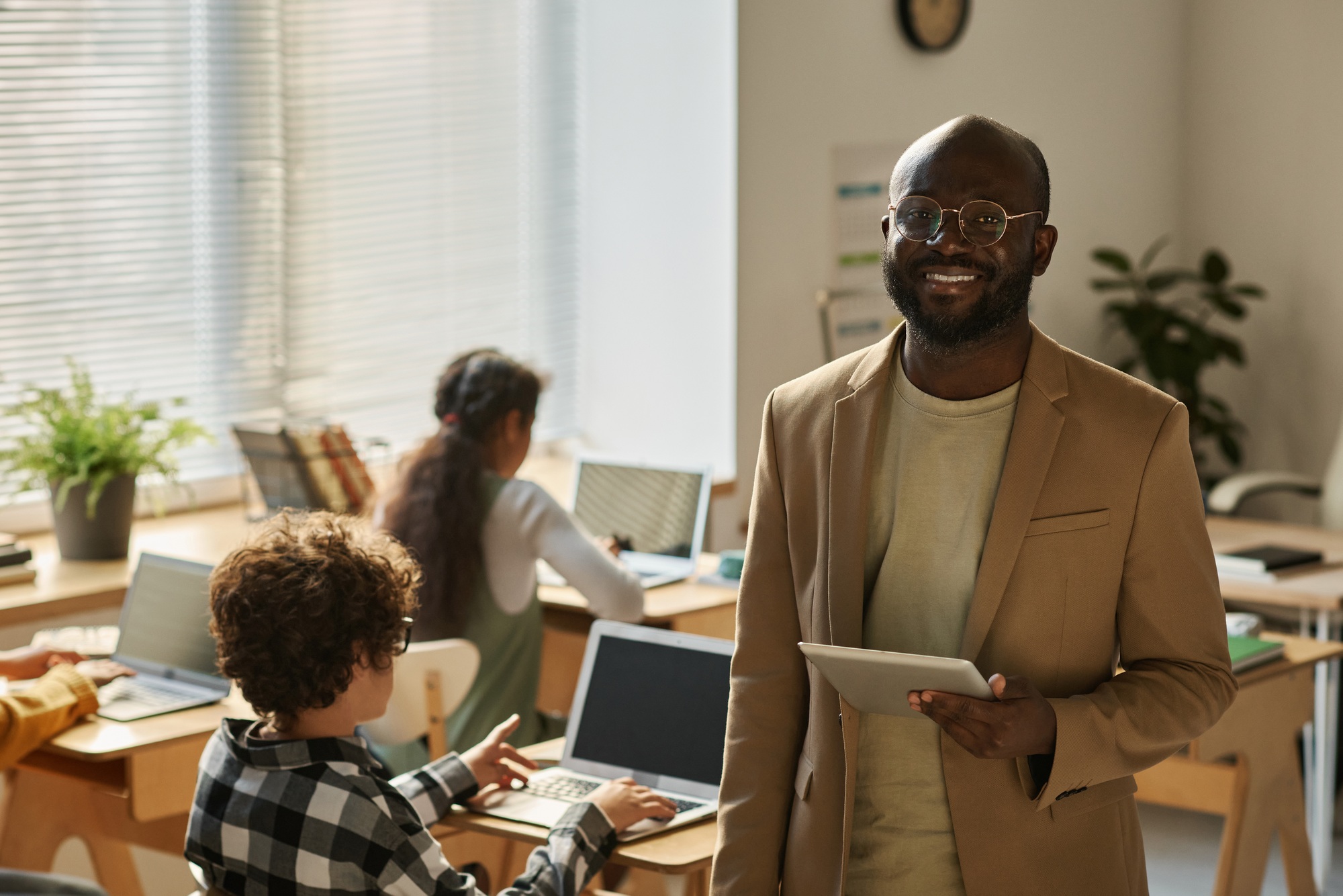 African American teacher standing at class