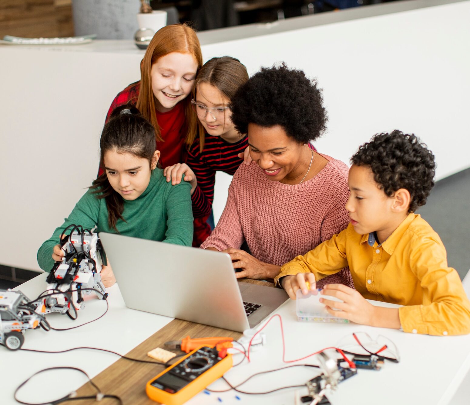 happy kids with their African American female science teacher